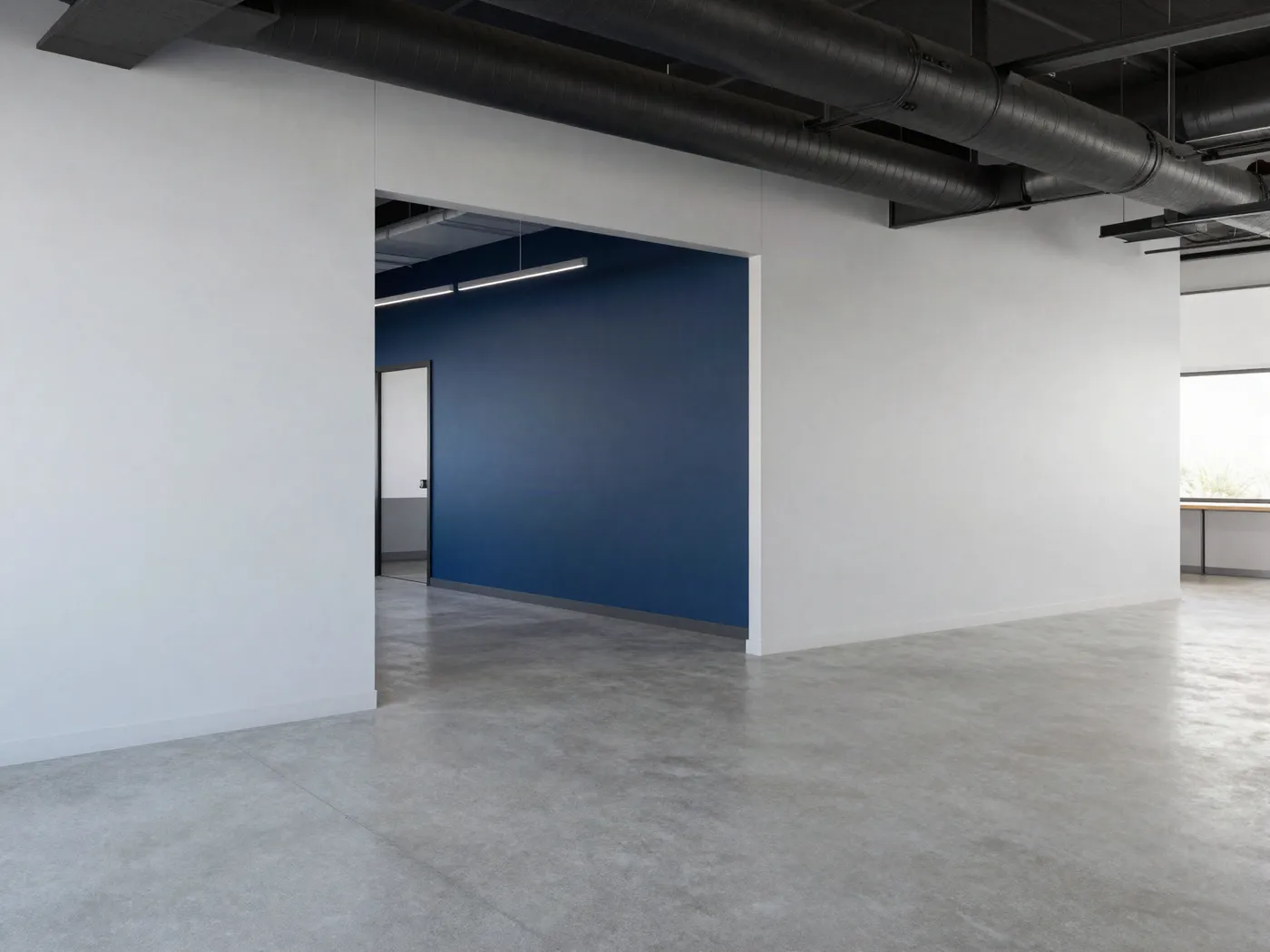 Open office with light gray walls, navy feature wall and black ceiling